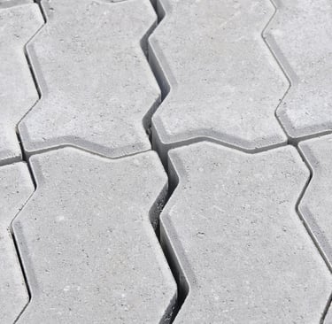 a close up of a tile floor with a cat sitting on the floor