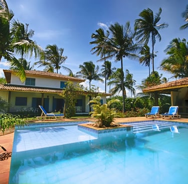 Luxury tropical villa with a private swimming pool, blue lounge chairs, and palm trees.