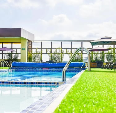 a pool with a swimming pool and lounge chairs