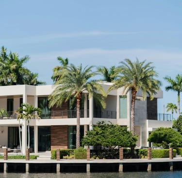 waterfront home with palm trees