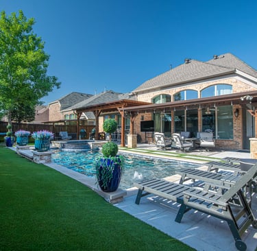 Luxury backyard patio with a swimming pool, lounge chairs, and a covered pergola outdoor living space.