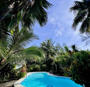 hidden backyard with a pool and bushes