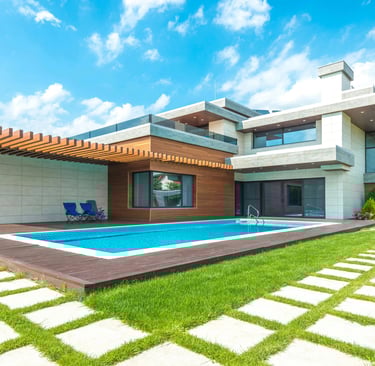 a house with a pool and a pool in the yard