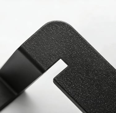 Close-up of a matte black textured metal bracket with a precision cut-out slot on a white background.