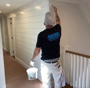 Michael Cummings painting interior walls in Duxbury, MA home using professional brushstrokes