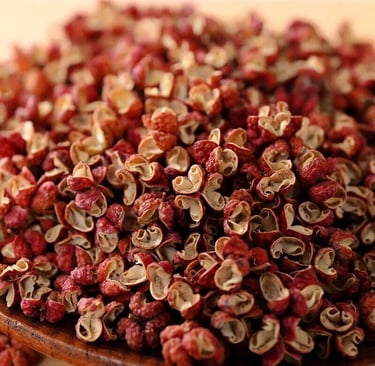Close-up of dried red Sichuan peppercorns, a pungent and numbing Chinese spice used in authentic Asian cuisine.