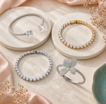 Elegant diamond tennis bracelets and a floral diamond cuff displayed on marble pedestals.
