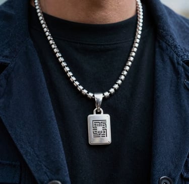 A close-up photograph of artistic fashion details in a North American / US urban setting. Fine metallic silver jewelry and dark navy textiles are captured with sharp focus, highlighting the fusion of music and fashion culture. The lighting is cinematic, emphasizing a bold, cutting-edge creative vision.