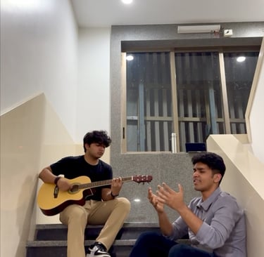 A guitarist and a vocalist doing a collaboration.