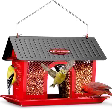 Red metal bird feeder with a cardinal and finches eating from a mesh seed container.
