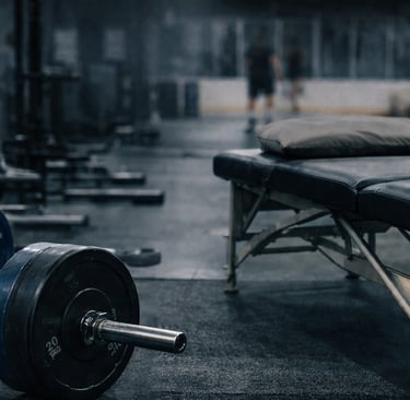 a gym room with a bench and a bench with a barbell