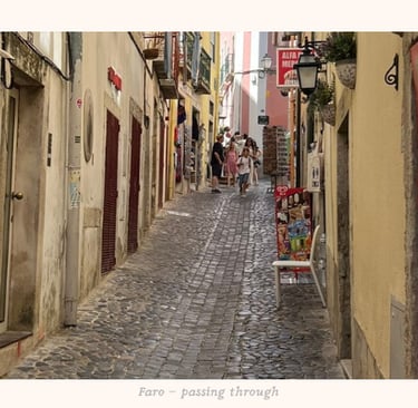 Gazing at the activity in an alley in Faro, Portugal
