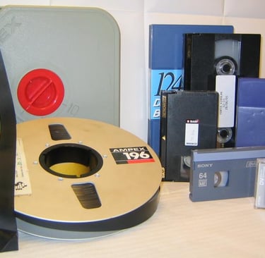 Collection of vintage video formats including VHS, Betacam, and DVCAM cassettes.