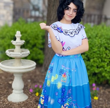 A Columbian inspired character standing by a garden fountain.