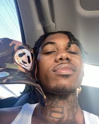 You African American male with neck tattoos.