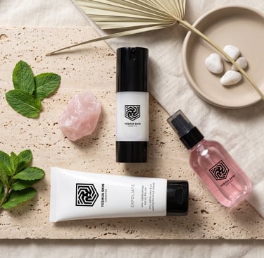 Yeshua Skin natural skincare products including mint exfoliator and facial mist on a stone tray.