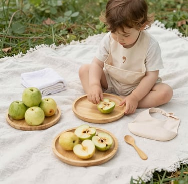 Close-up of colorful bamboo children's plates arranged on a wooden table with fresh fruits.