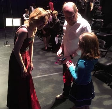 Violinist performer and teacher greets her future student and their parent after a concert