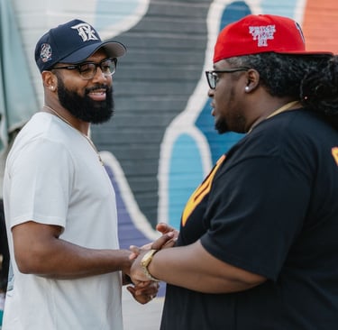 a man in a white shirt and a man in a red hat