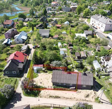 a large house with a red square shaped area in the middle of a small town