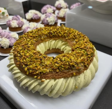 Gourmet pastry with piped cream and crushed pistachios.