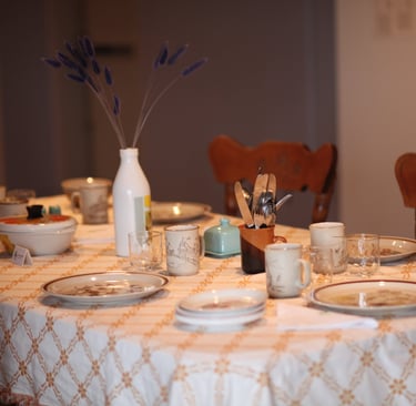 Empty table with recycled kitchenware in a gallery playing sounds of cooking and shared meals.