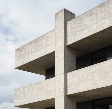 A vertical architectural photograph of a minimalist concrete structure in Olinda. The building features clean lines and sharp geometries against a bright sky. The color palette is dominated by soft off-white and charcoal black accents, with harsh shadows emphasizing technical rigor.