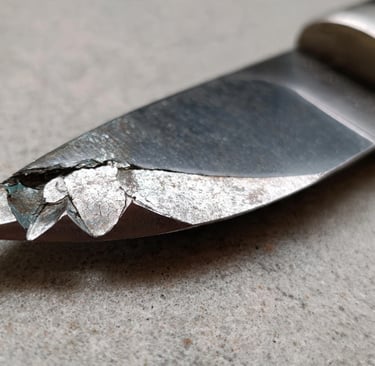 a damaged knife and a knife blade on a knife