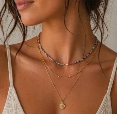 layered gold necklaces with a colorful beaded choker and sunburst pendant.