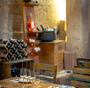 Rustic Tapastan dining room with wooden tables, wine racks, and elegant glassware.