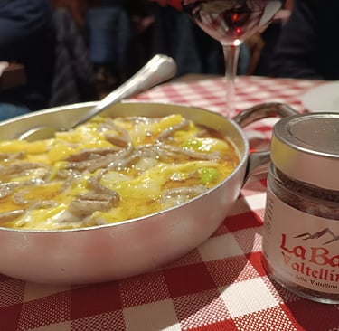 Piatto di pizzoccheri della tradizione valtellinese serviti a tavola