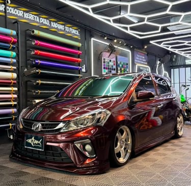 Perodua Myvi wrapped in gloss maroon vinyl