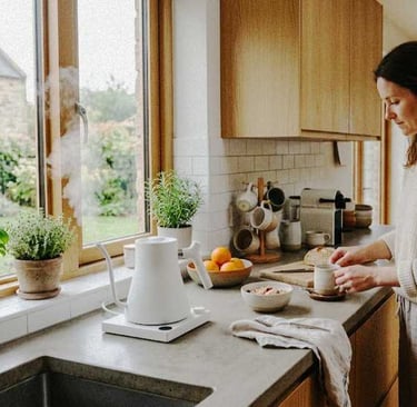 Woman in a cozy kitchen making tea while lightly tidying the counter during a simple daily routine