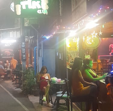 Thai women sat outside Nees Tiki Club on Petchkasem Road in Hua Hin