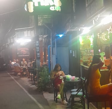 Thai women sat outside Ness Tiki Club in Hua Hin