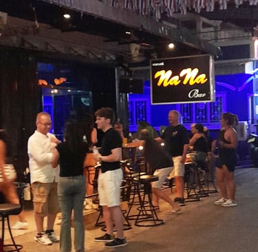 Thai women and bar customers outside bar at Soi 80, Hua Hin in Thailand