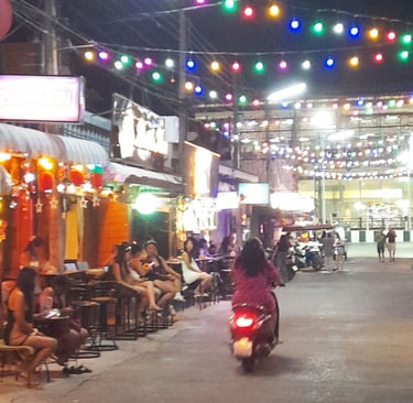 Thai women sat outside bars on Soi 80, Hua Hin in Thailand