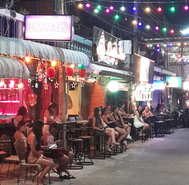 Thai women sat ouside bars on Soi 80, Hua Hin in Thailand