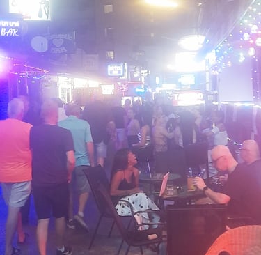 Thai women, tourists and bars on soi Bintabaht, Hua Hin in Thailand