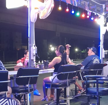 Thai women and customer sat in bar near Soi 94 in Hua Hin