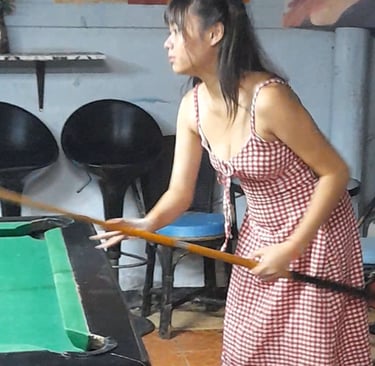 Thai woman playing pool at Nees Tiki Club, Hua Hin