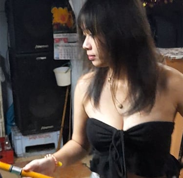 Thai woman playing pool at bar near Soi Bintabaht in Hua Hin