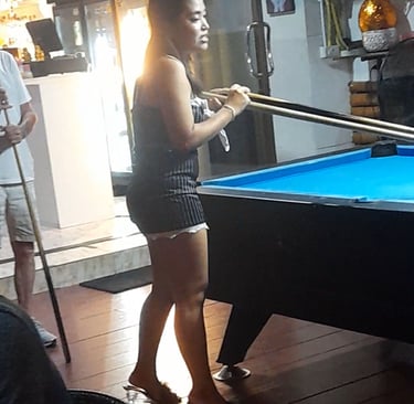 Thai woman playing pool at bar on Soi 94 in Hua Hin