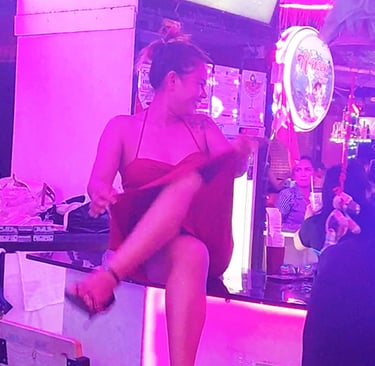 Thai woman sat on bar at Wonderland bar complex, Hua Hin