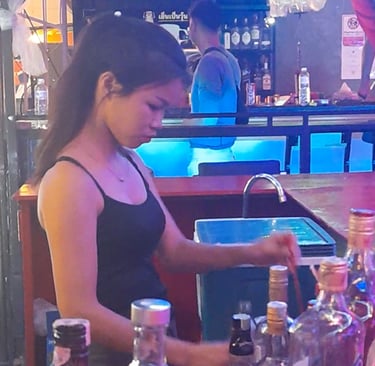 Thai woman preparing drinks at bar in Wonderland, Hua Hin