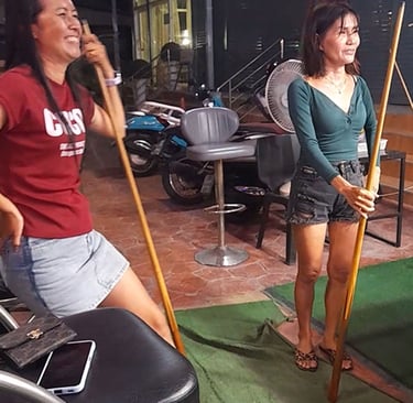 Thai women smiling at pool table at bar near Soi 94 in Hua Hin
