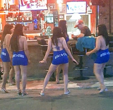 Thai women dancing outside bar on Soi 80 in Hua Hin