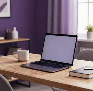 Softly lit home office in a North American apartment. A sleek laptop sits on a light wood desk next to a ceramic mug and a hardcover novel. Deep purple and soft lavender accents in the room decor. Warm, professional atmosphere.