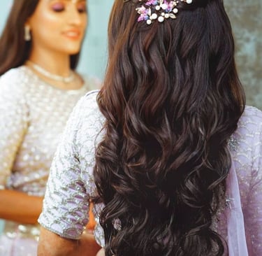 Elegant bridal hairstyle with soft curls and floral hair accessories.