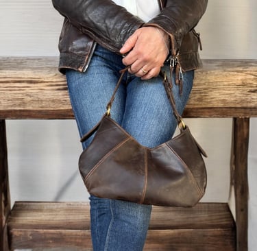 a woman in jeans and a leather jacket